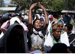Women mourn during the funeral ceremony of a primary school teacher who family members said was shot dead by military forces during protests in Oromia